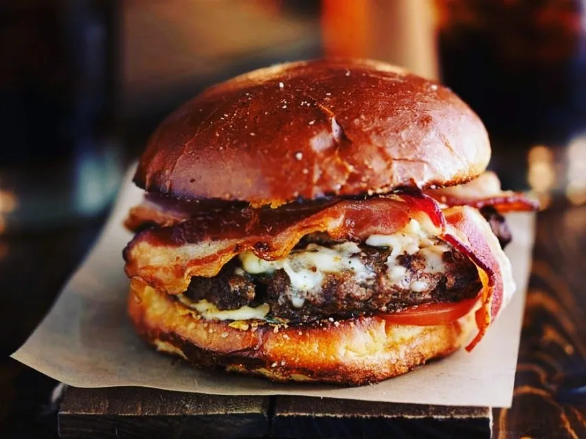 Bacon and blue cheese burger on a pretzel bun